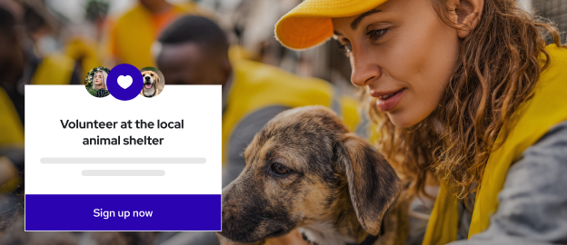 A woman wearing a yellow cap and vest gently holds a puppy while volunteering at an animal shelter. A sign in the foreground reads "Volunteer at the local animal shelter. Sign up now."