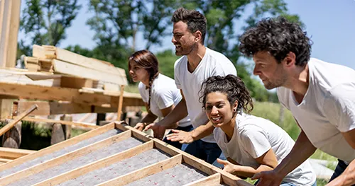 Group of people volunteering on a construction-based volunteer project.