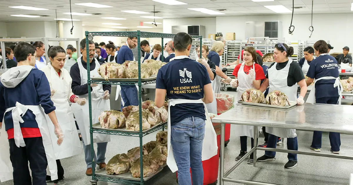 Image of USAA's client story within the Benevity platform, featuring a custom banner image of employees volunteering