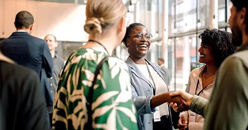 A group of people connecting at a conference event.