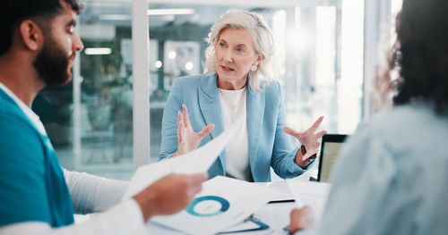 3 employees meeting with graphics and sheets