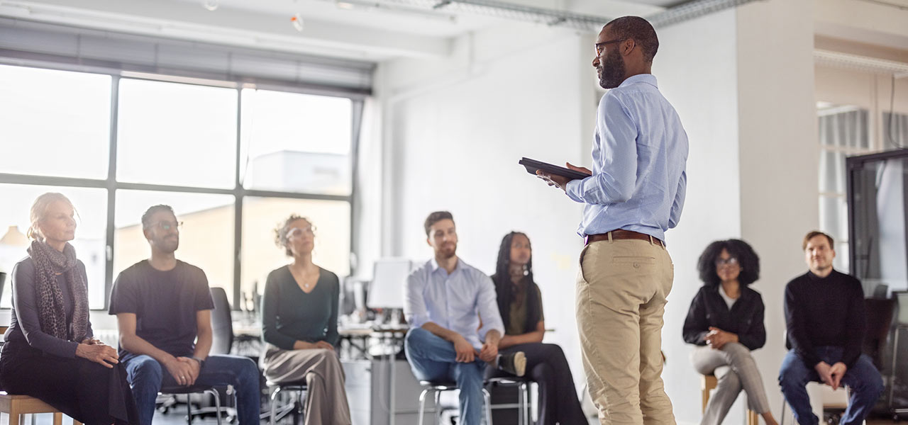 A person presenting a conference at work
