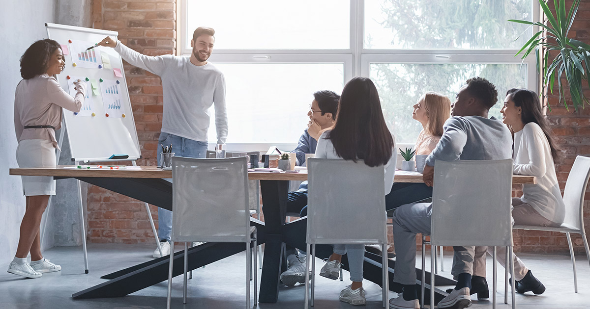 Group of employees in a meeting discussing strategy