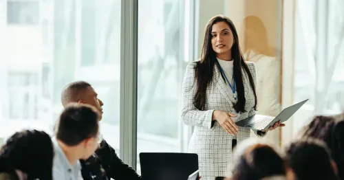 Corporate executive giving a presentation in an office.