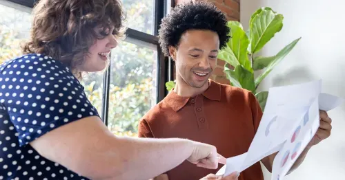 Man and woman looking at data in the office