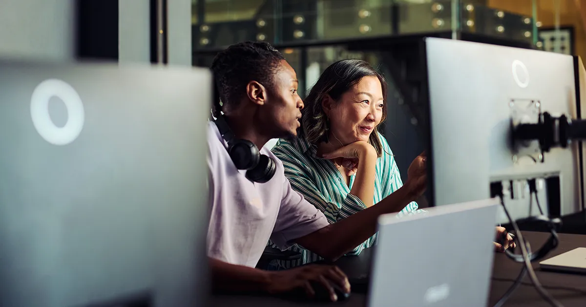 Employees in an office looking at a computer screen.