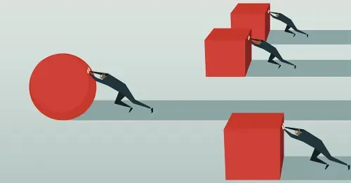 Employees in an office looking at a computer screen.