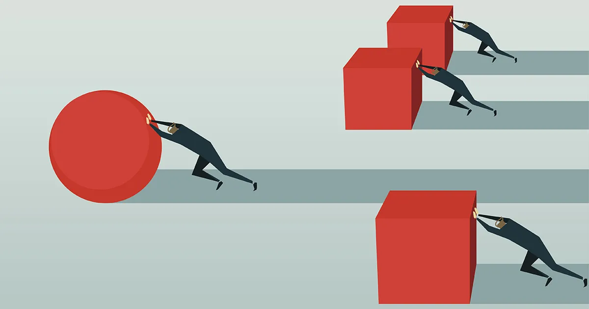 Employees in an office looking at a computer screen.