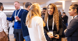 Professionals networking at a conference, engaging in conversation and building connections at an event