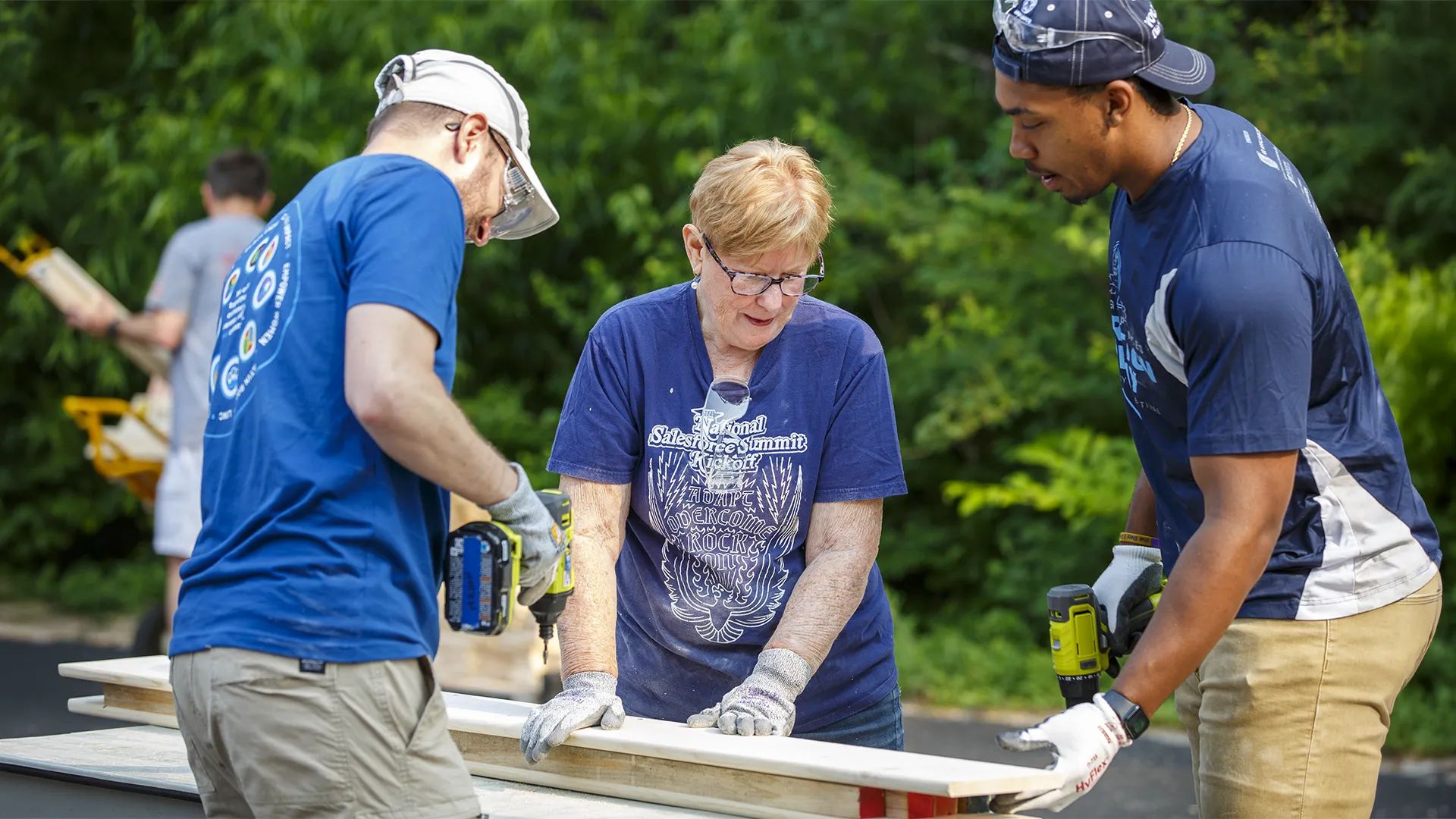 3 GE Appliances employees drilling holes in wood during a volunteering opportunity