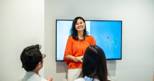 Executive leader presenting performance metrics to an executive team