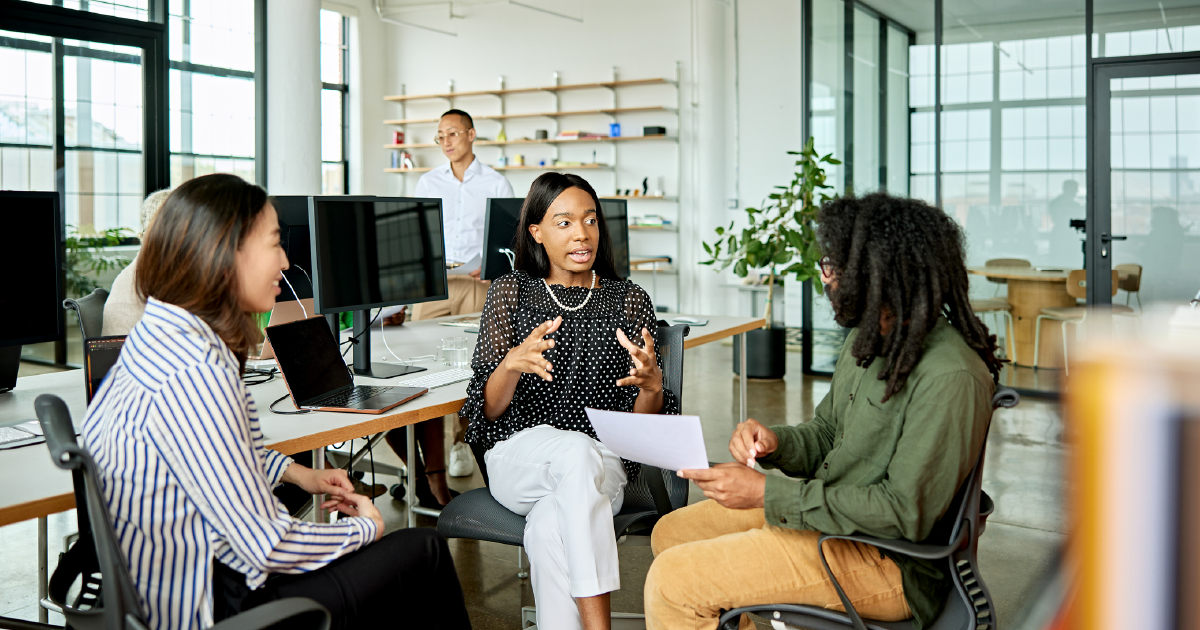 Three colleagues seated in an office, discussing strategy