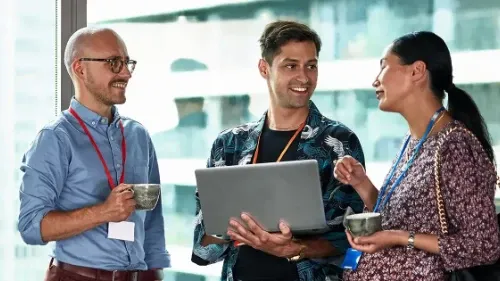 Professionals networking at a conference, engaging in conversation and building connections at an event.