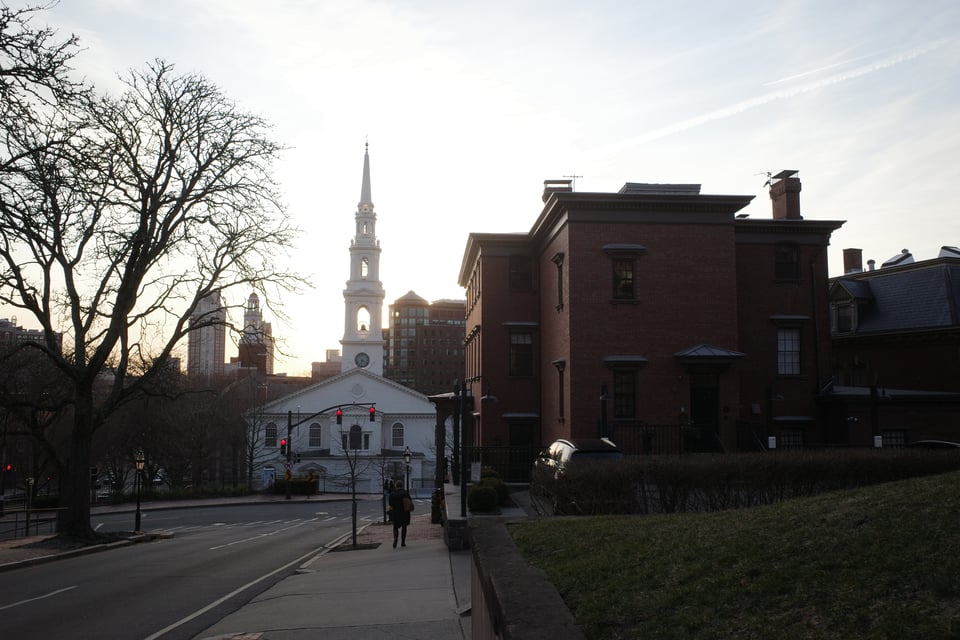Angell Street in Providence at sunset, with the First Baptist Church and red brick buildings in view