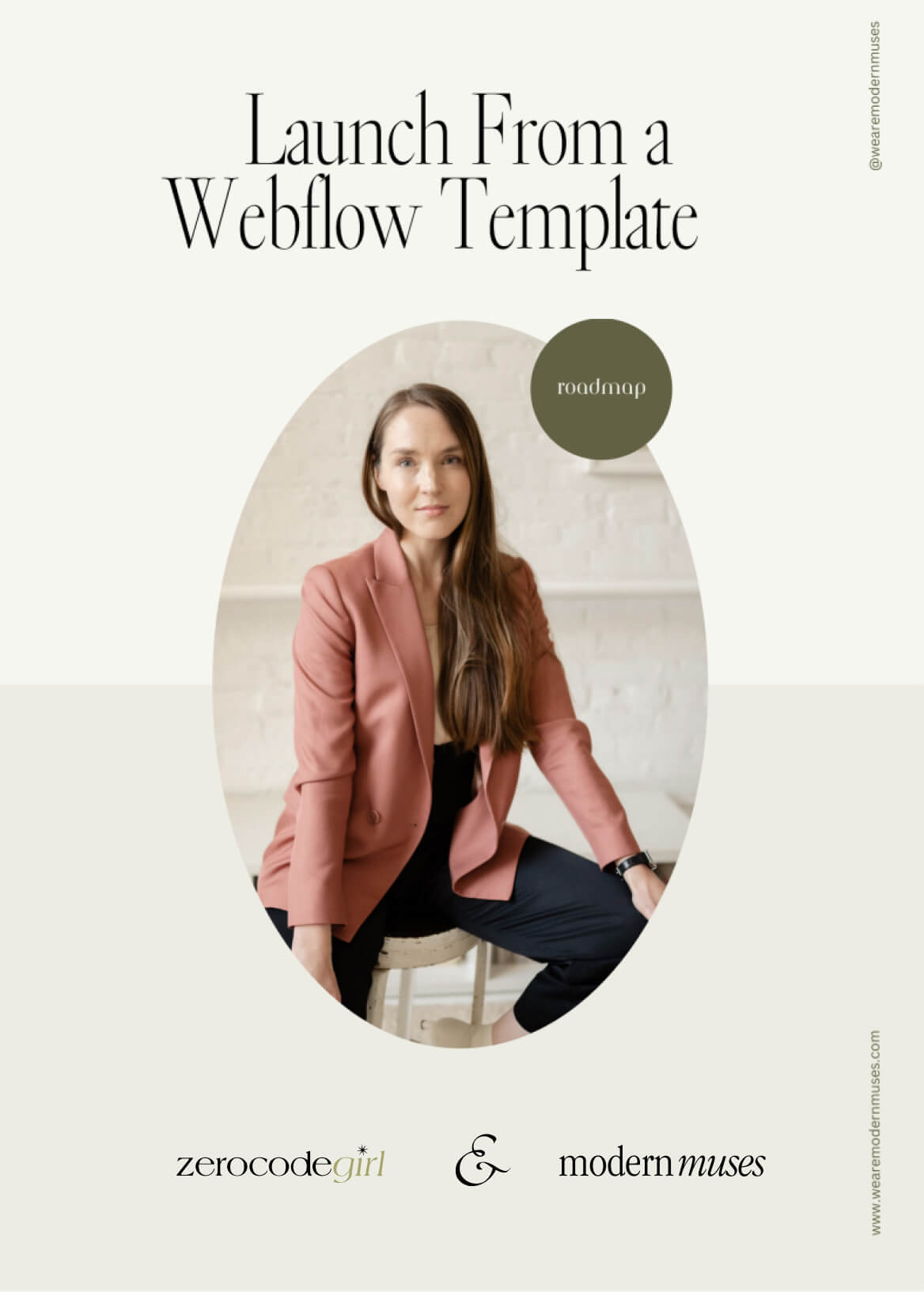 Woman with long brown hair sitting on a stool wearing a pink blazer and black pants against a light background.