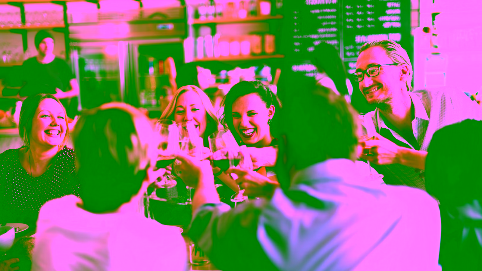 people smiling around a table at a restaurant