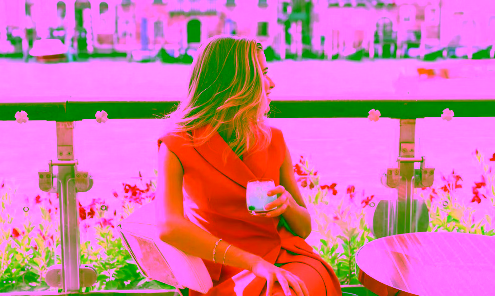 women sitting in a hotel outdoor bar on the water in the canals of Venice Italy
