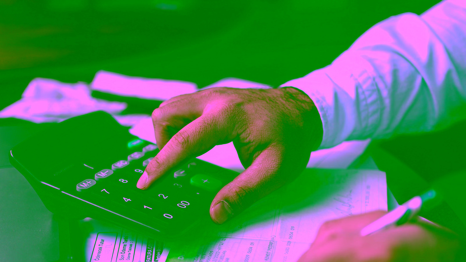 Person using calculator and smartphone to implement 50-30-20 budgeting rule for money management