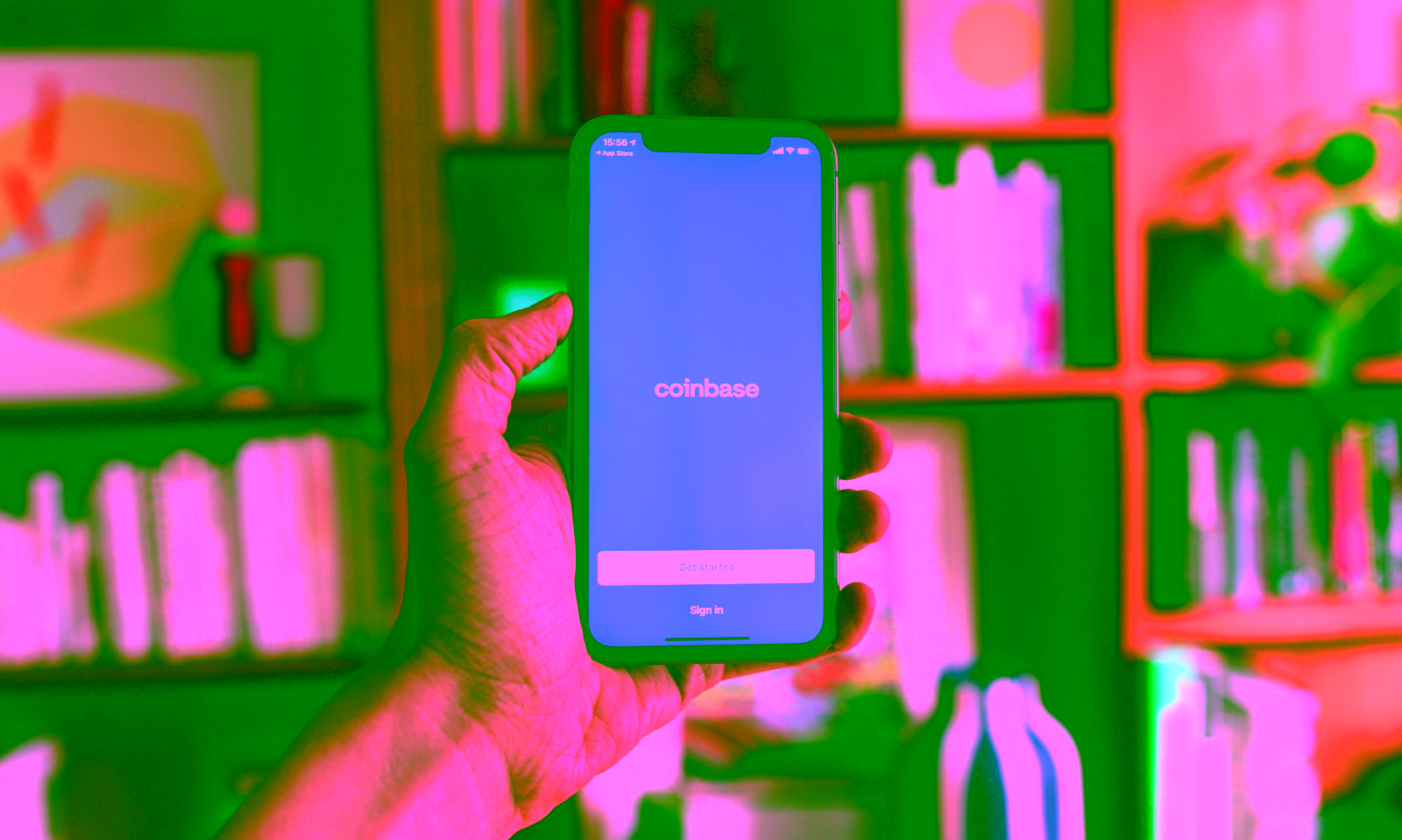 person holding a phone using the coinbase app