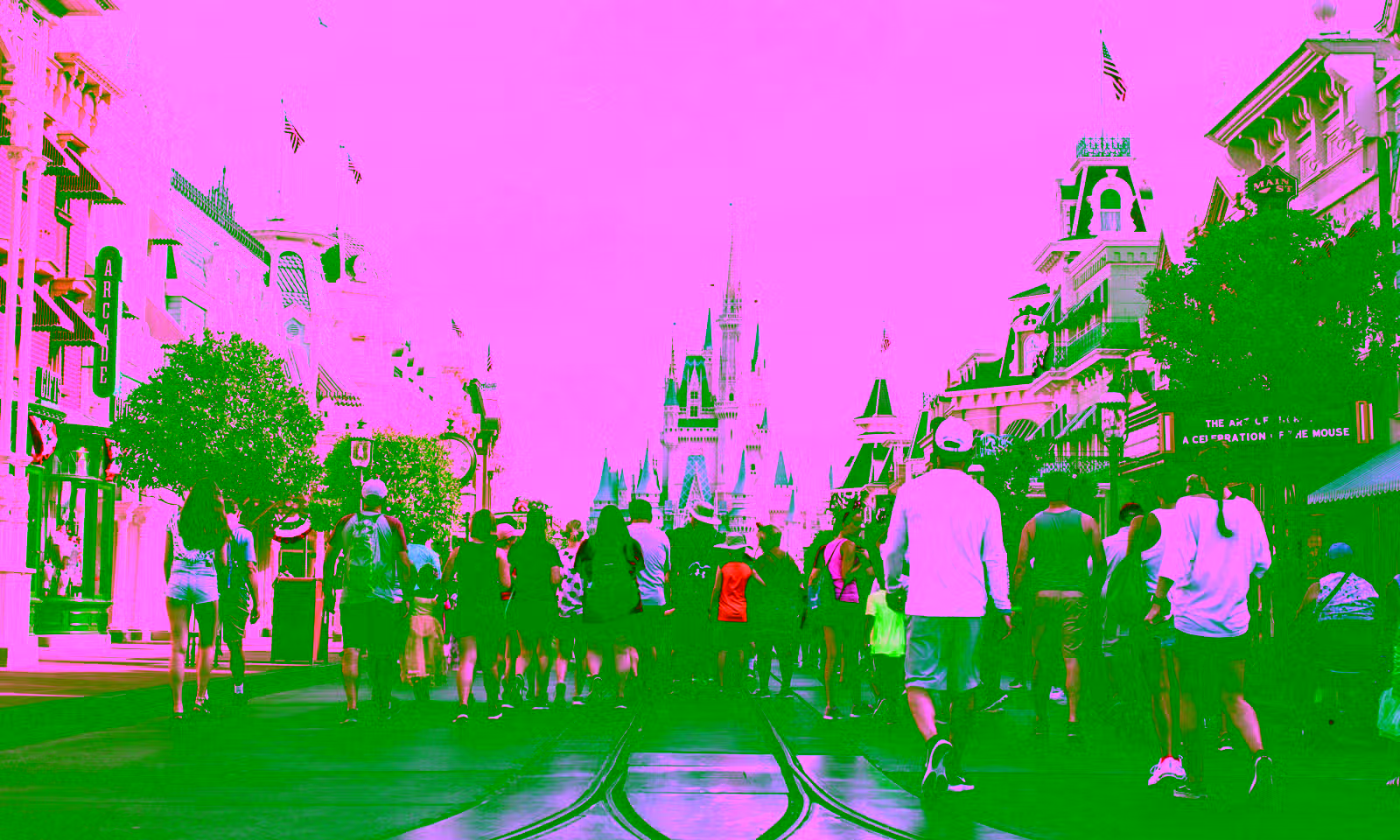 disneyland main street with people walking toward the castle