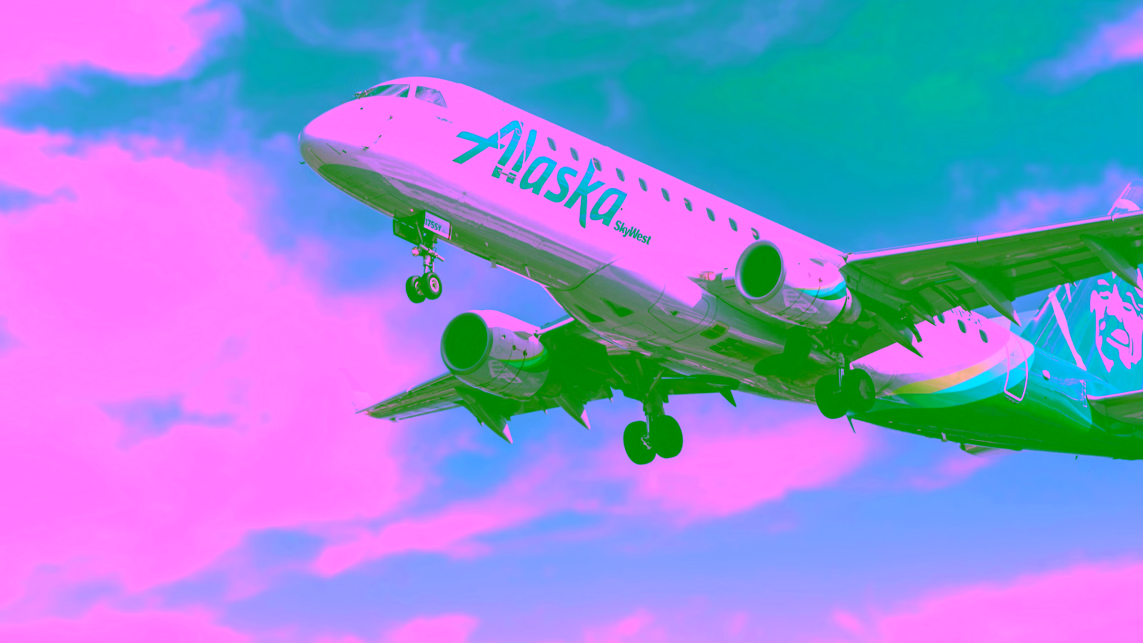 alaskan airlines plane flying through sky