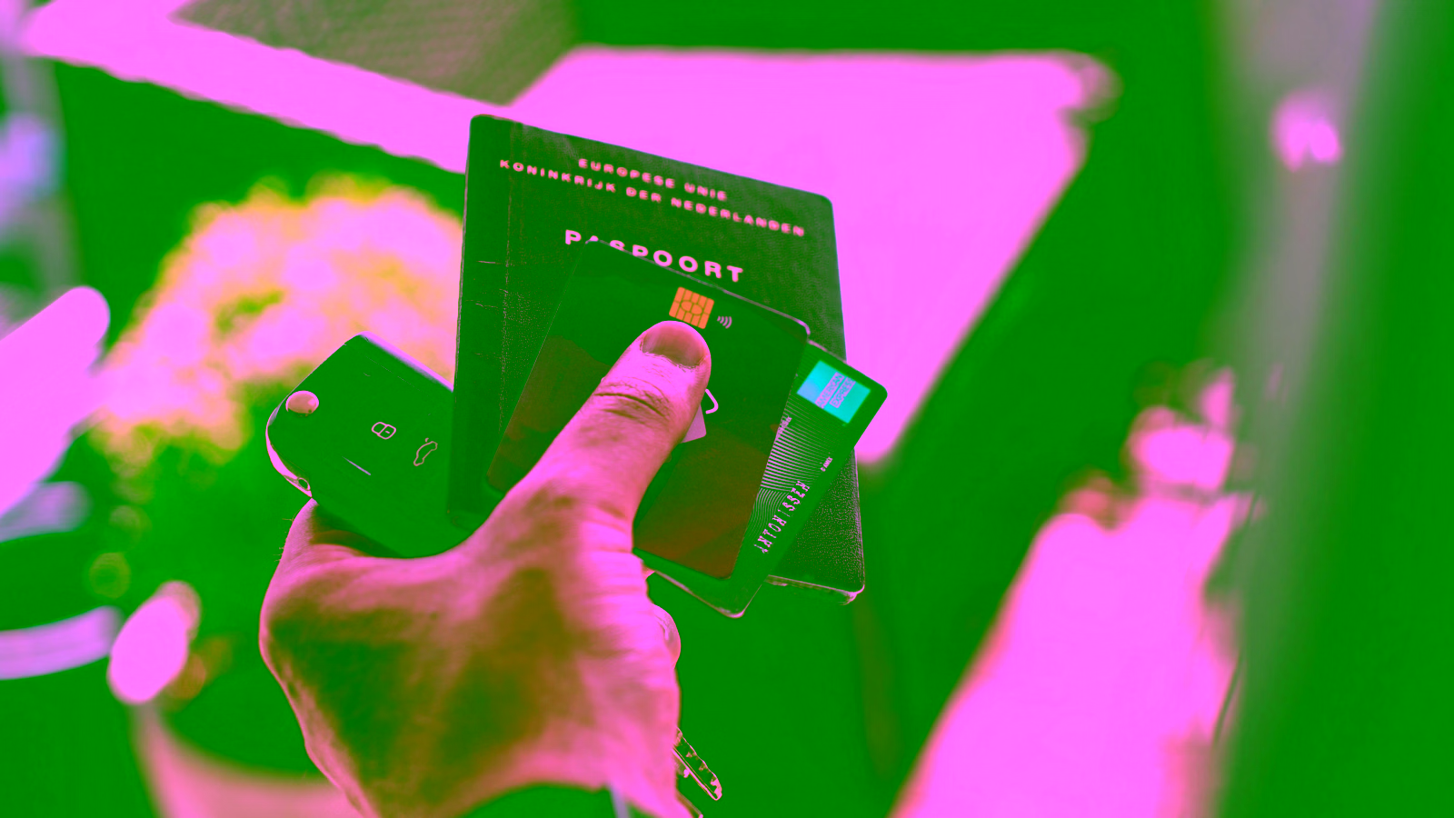 Passport, credit cards, and car key in hand