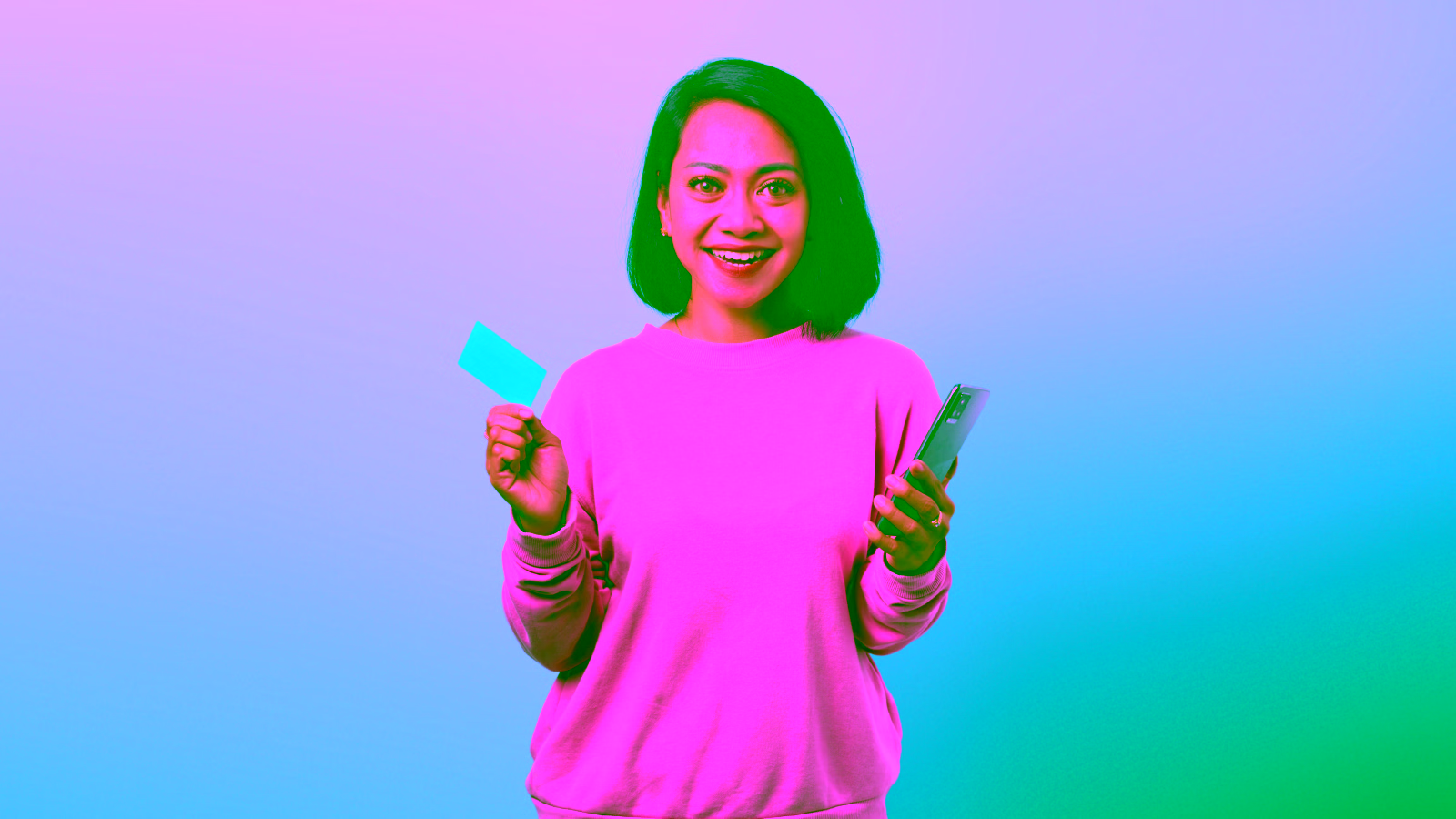Happy woman showing credit card and phone