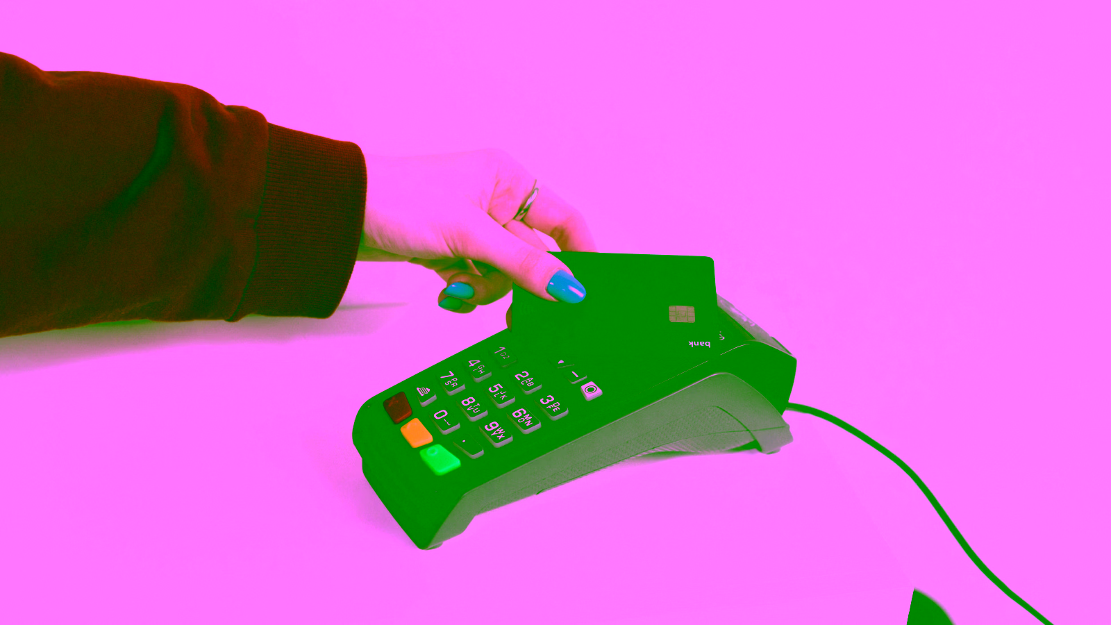 Hand making contactless payment with credit card on POS terminal