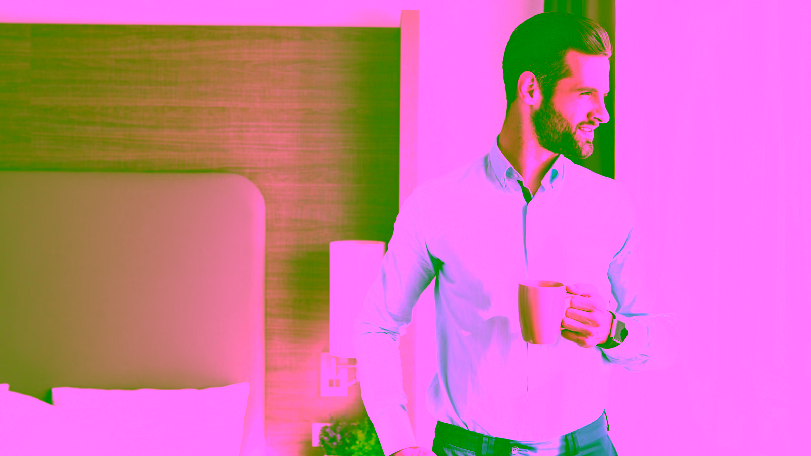 Man drinking coffee by window