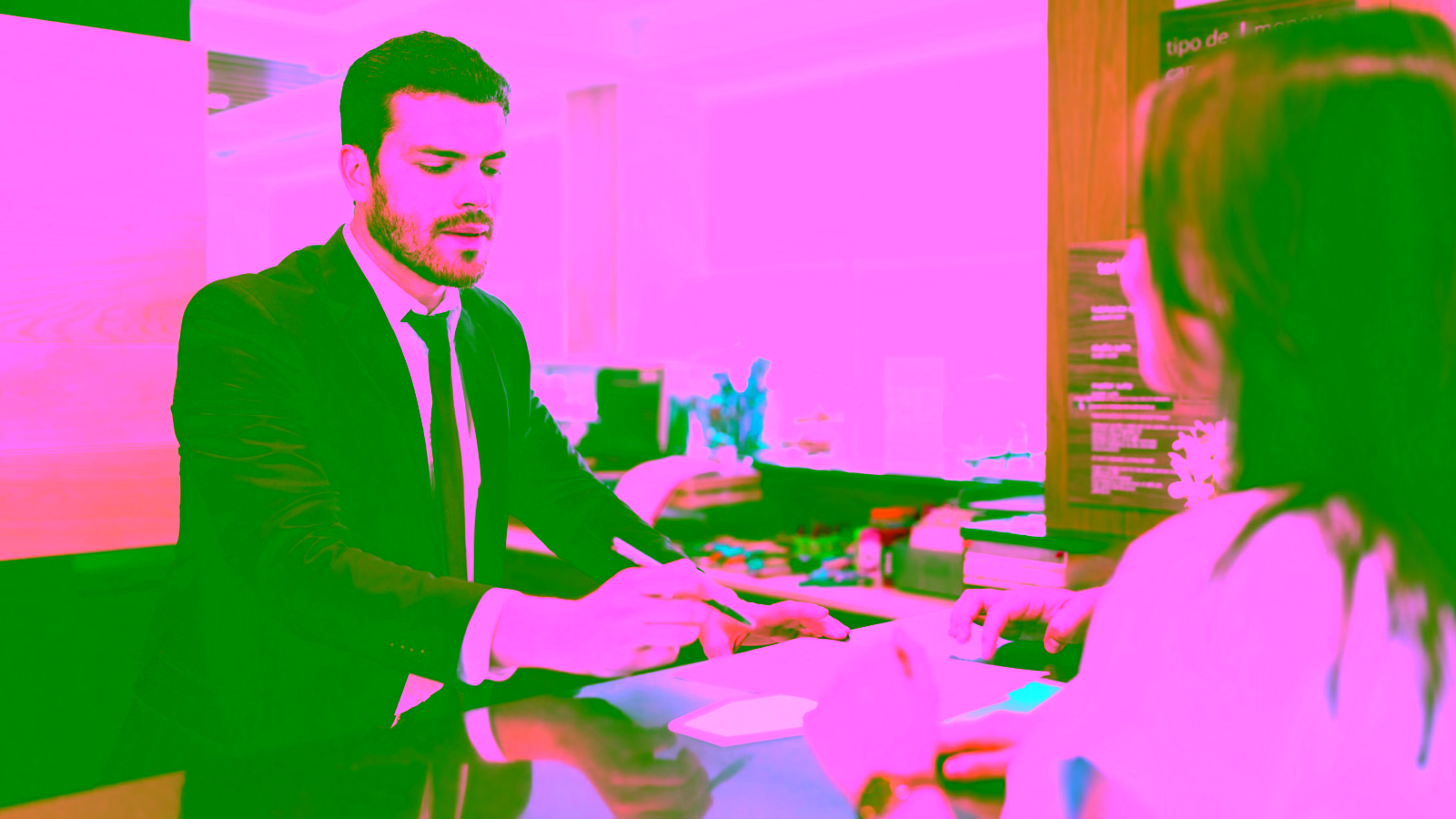 Man helping woman with papers