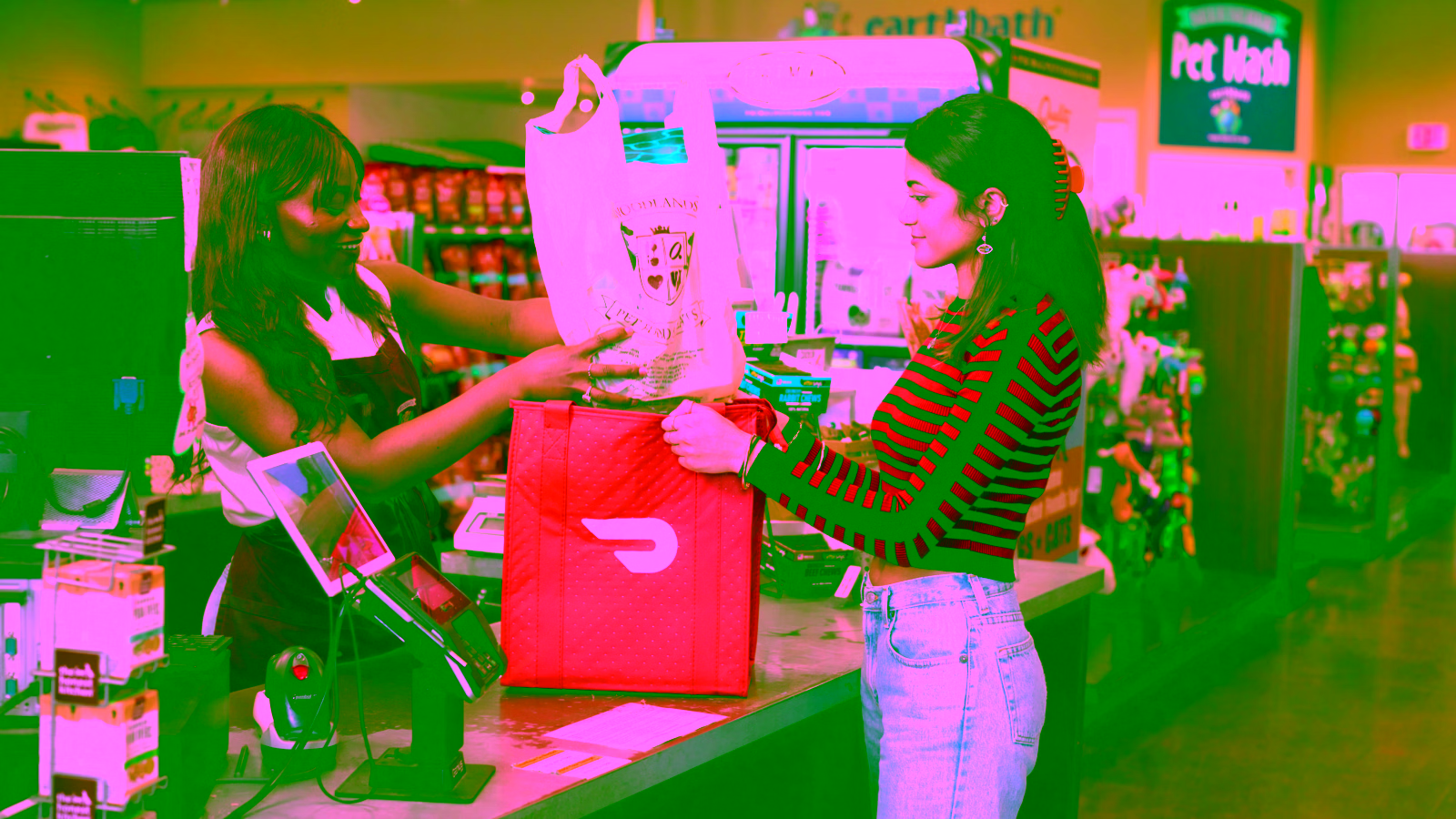 Cashier giving a grocery bag to a customer