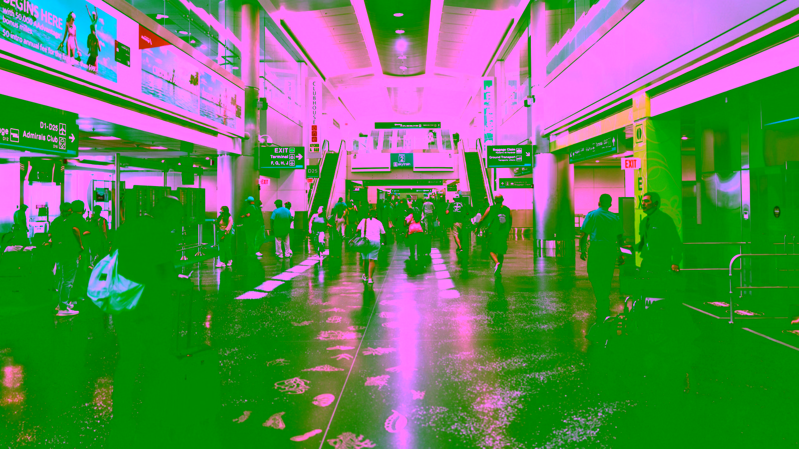 Travelers walking through a busy airport terminal