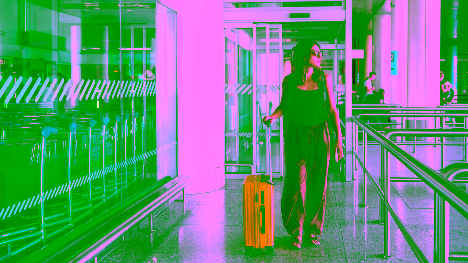 Traveler with yellow suitcase at airport terminal