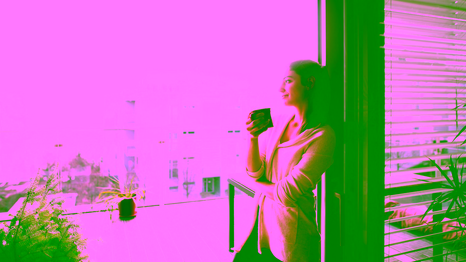 Woman enjoying coffee on balcony