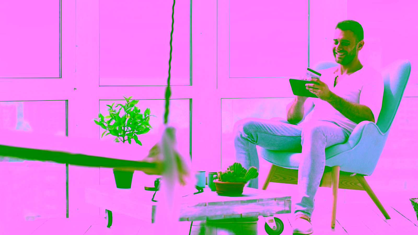 Man paying online with credit card and tablet.