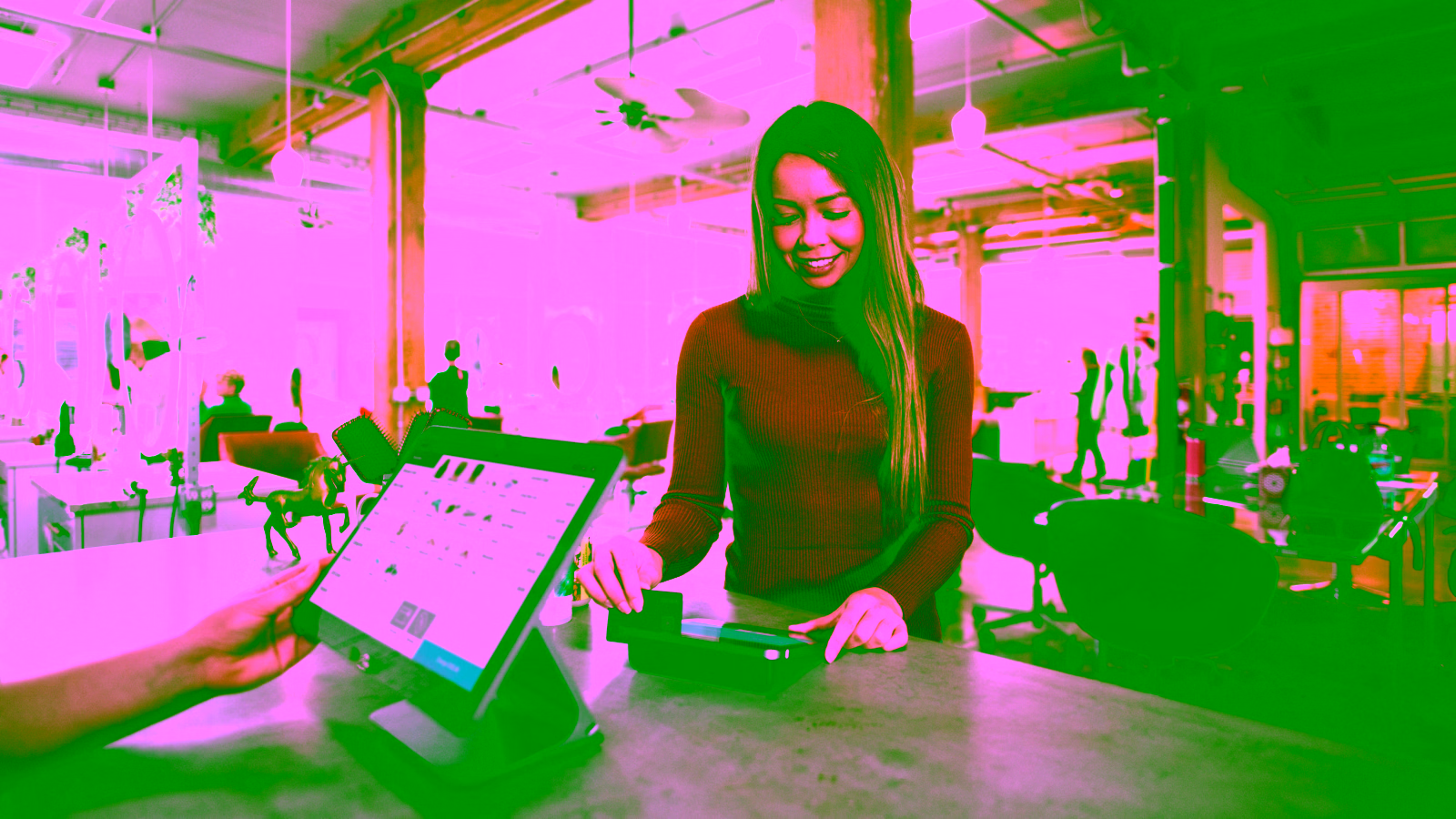 Woman paying with credit card at store counter