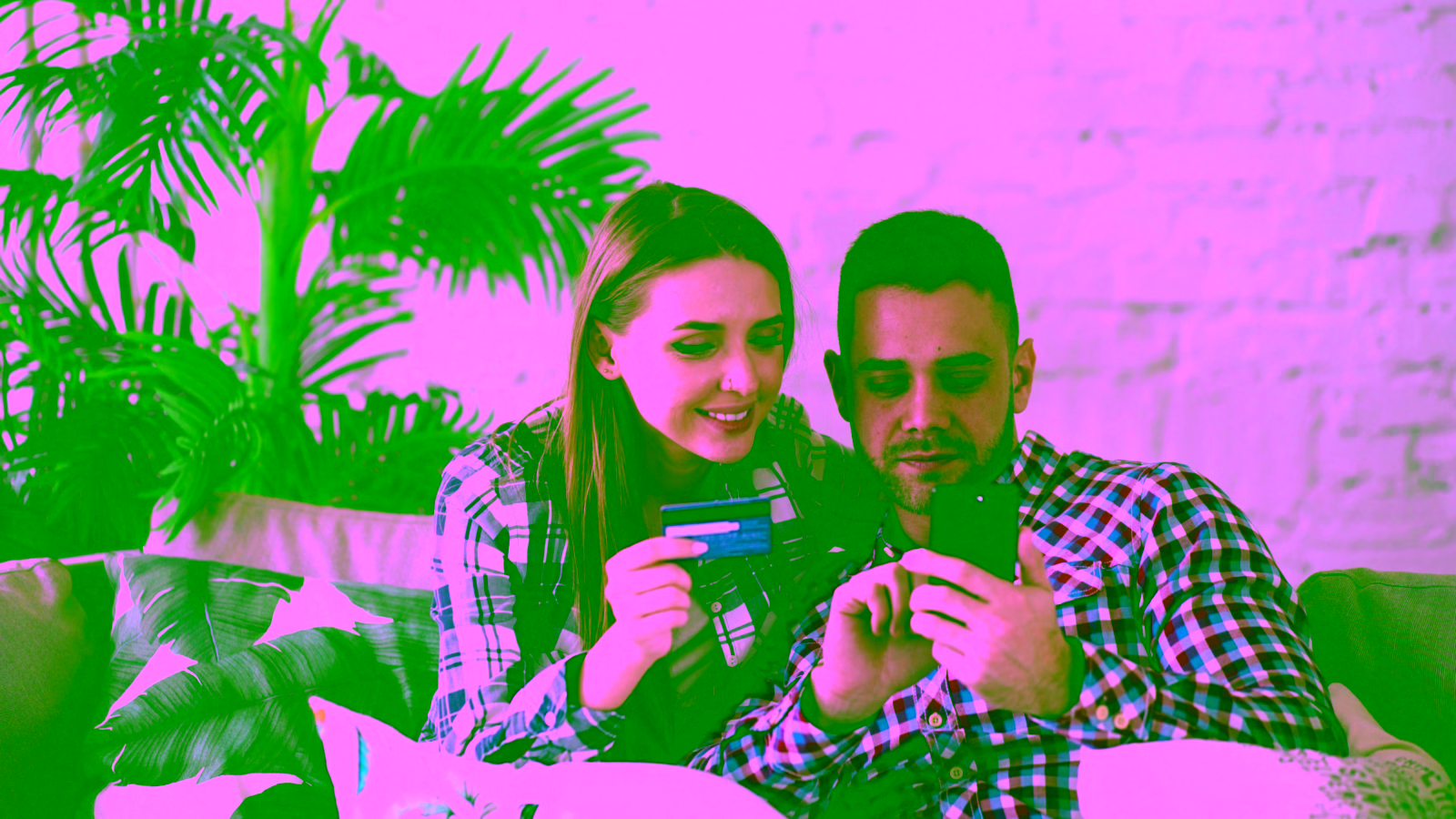 Couple using credit card for online purchase