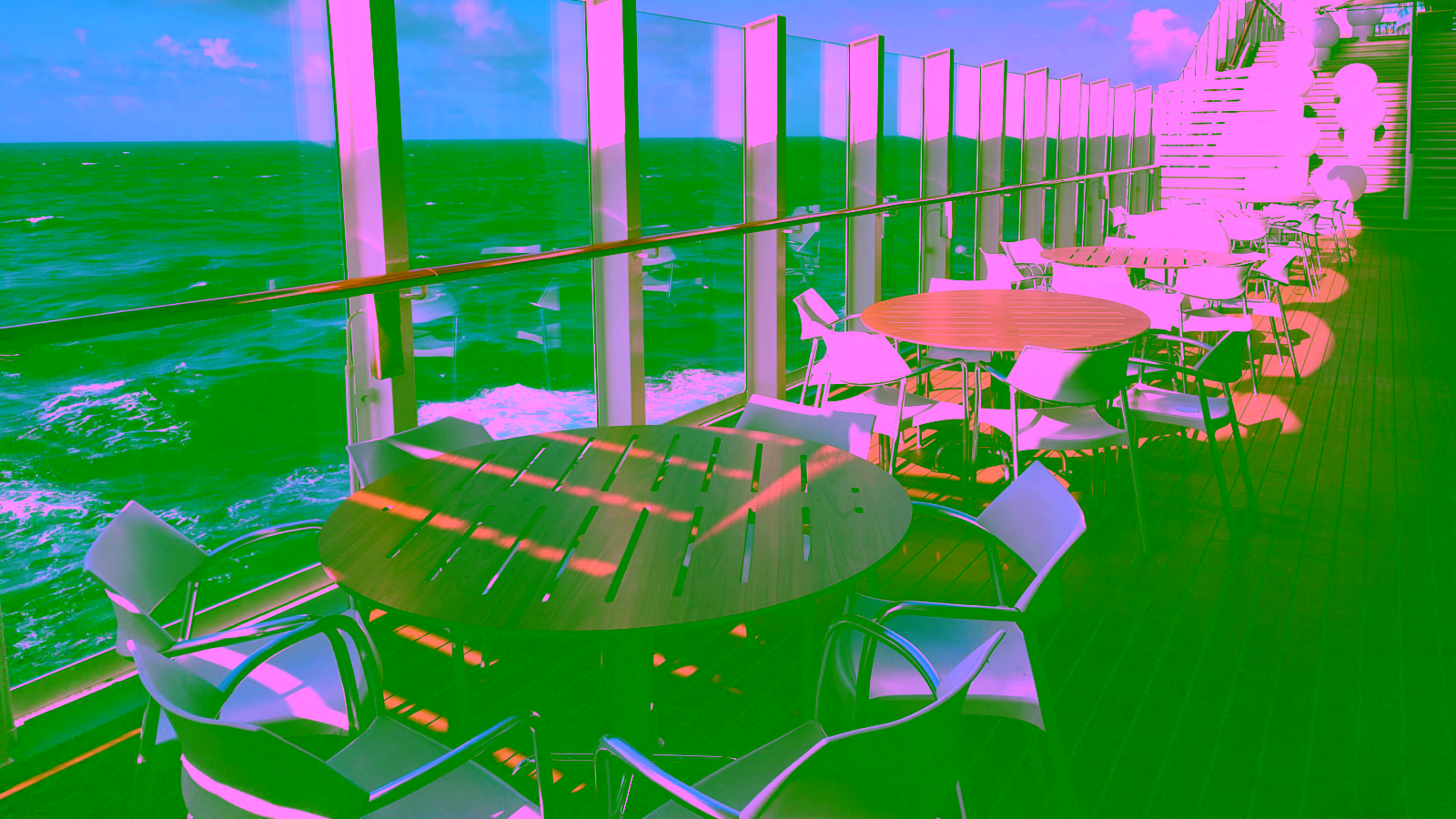 Ocean view from cruise ship deck with seating area