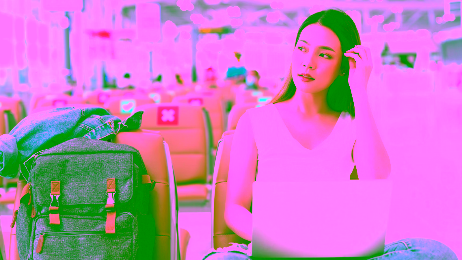 Woman using laptop while waiting at the airport