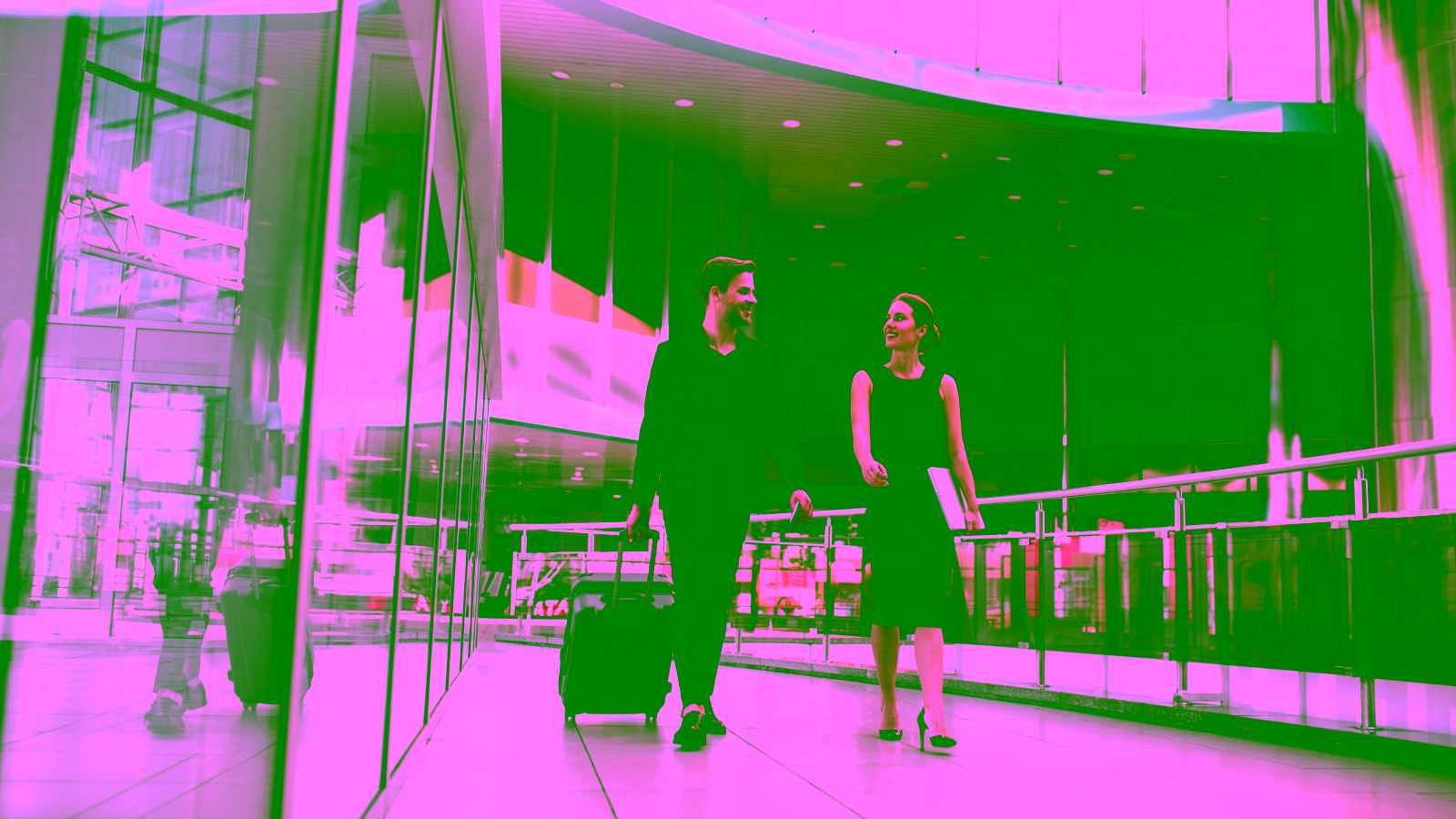 Business travelers walking through airport terminal