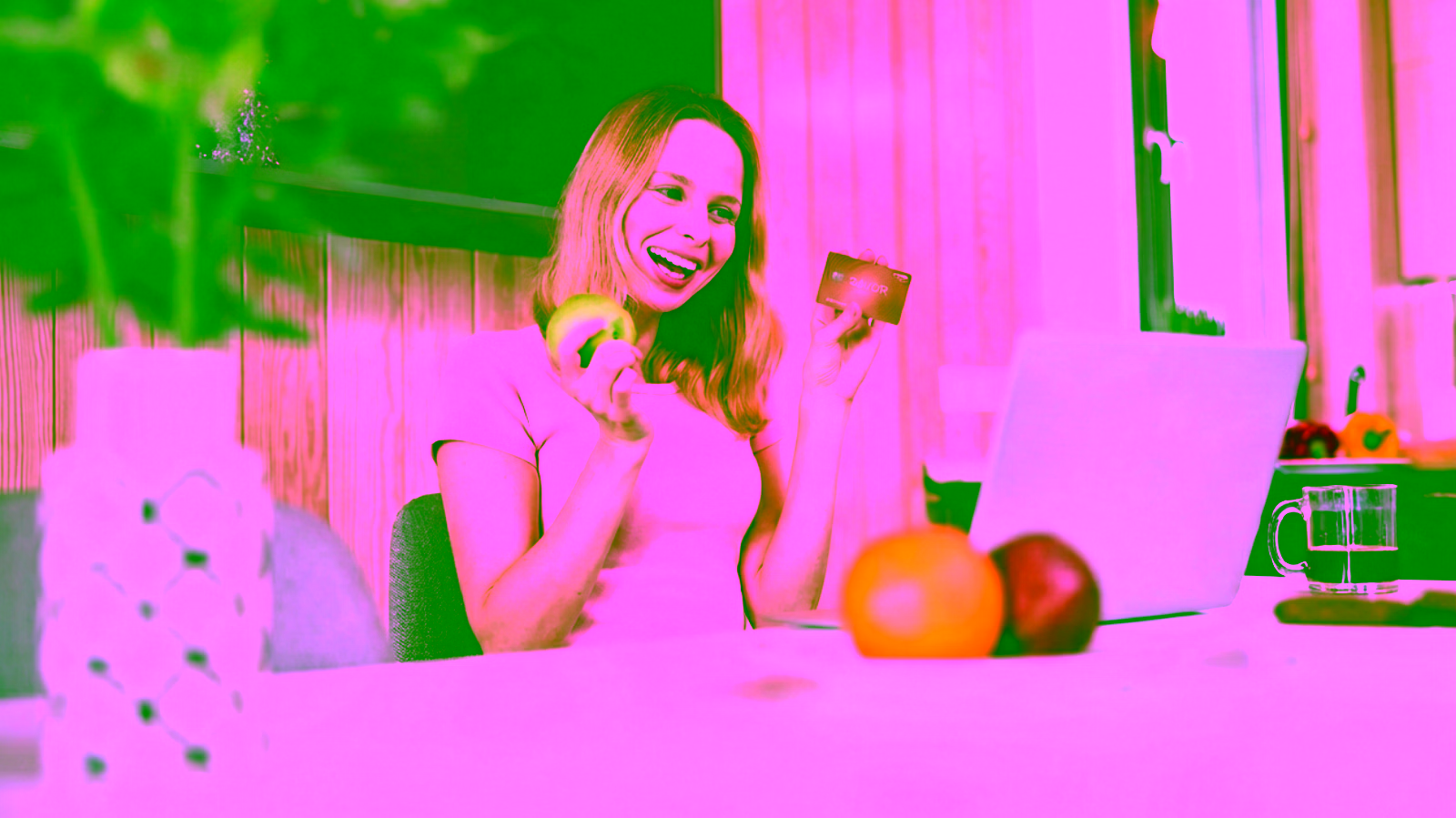 Woman holding Capital One Savor credit card