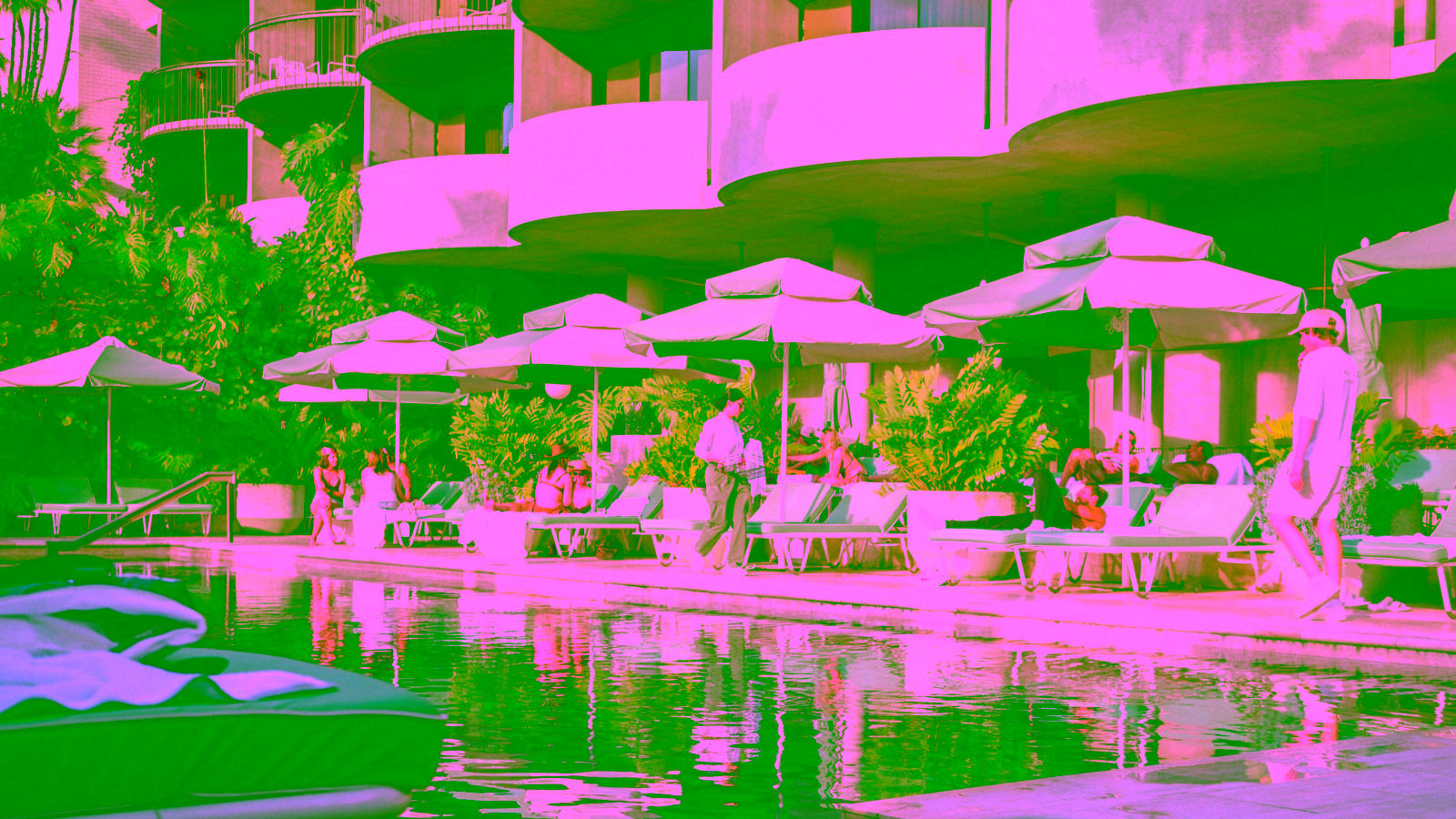 Guests relaxing by a luxury hotel pool