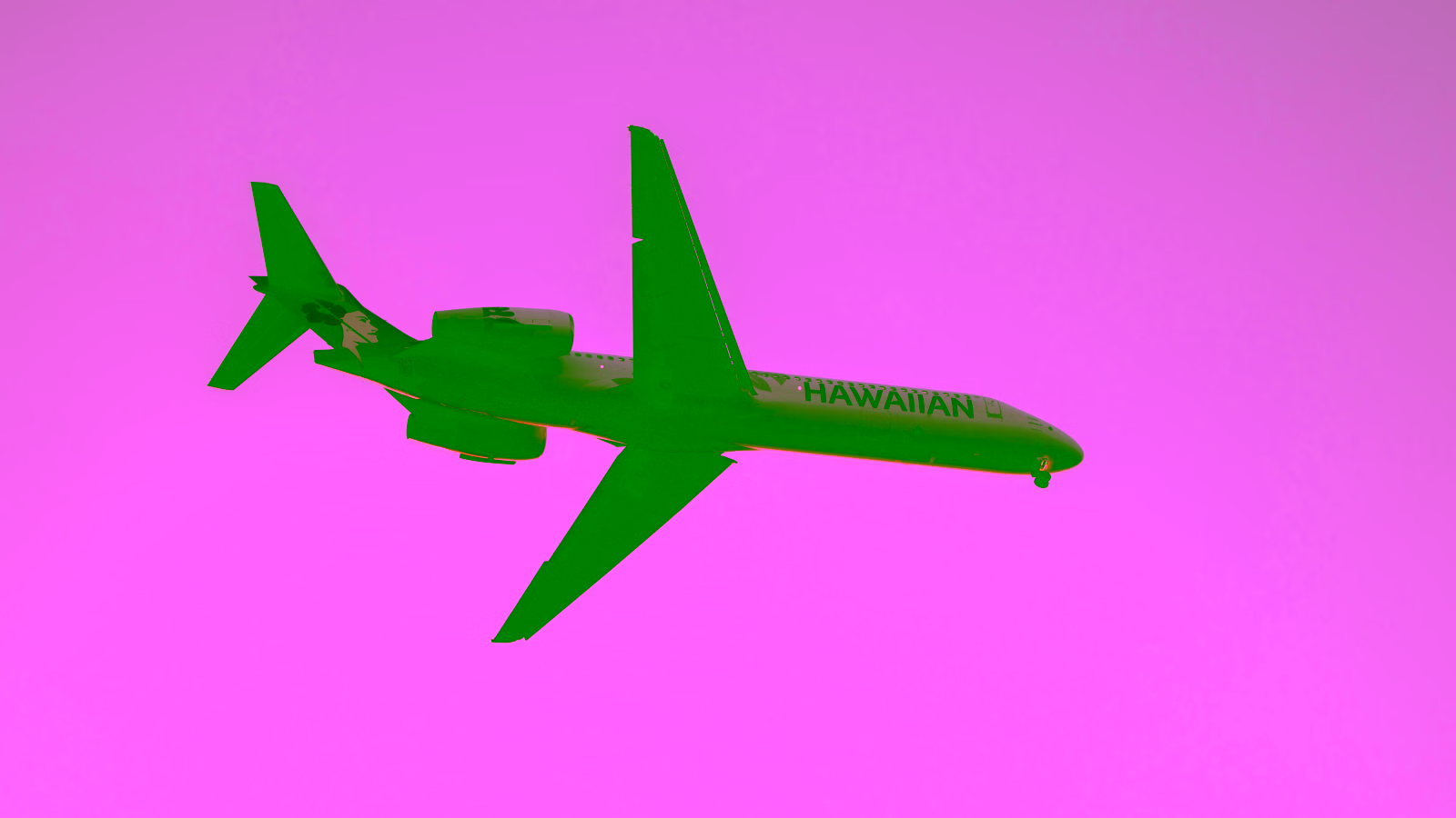 Hawaiian Airlines plane in sunset sky