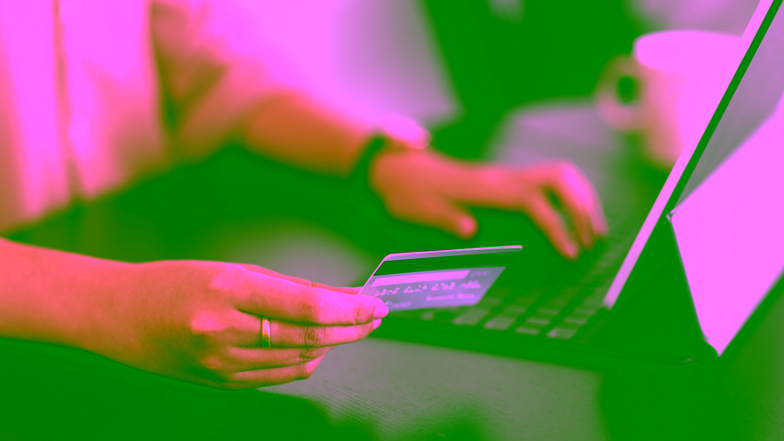 Person using a credit card to shop online on a laptop