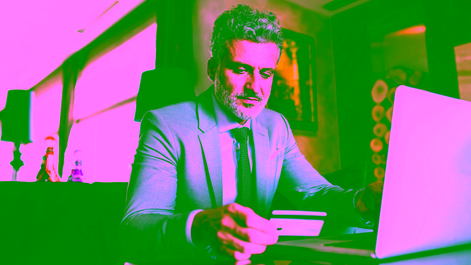 Man using a credit card on a laptop