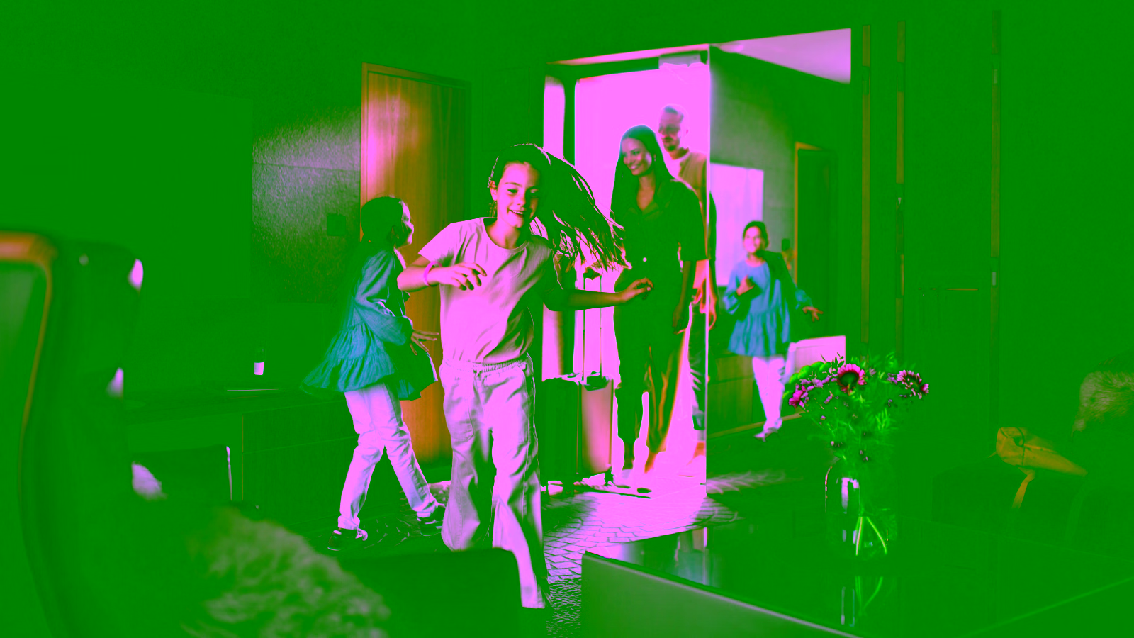 Family entering hotel room with luggage.