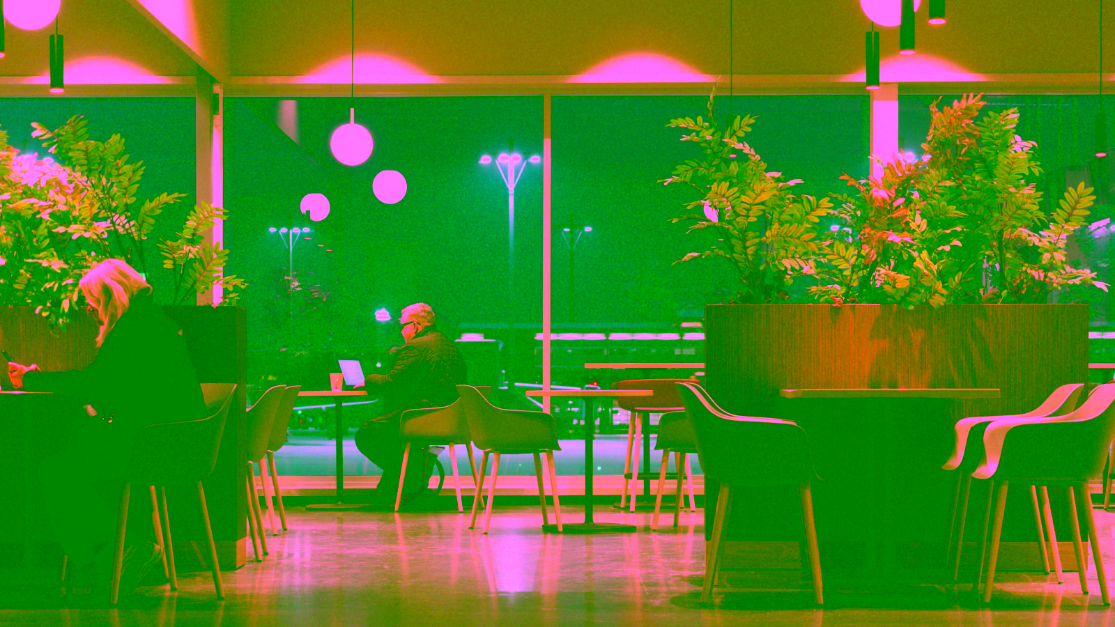 Airport lounge seating area with evening view