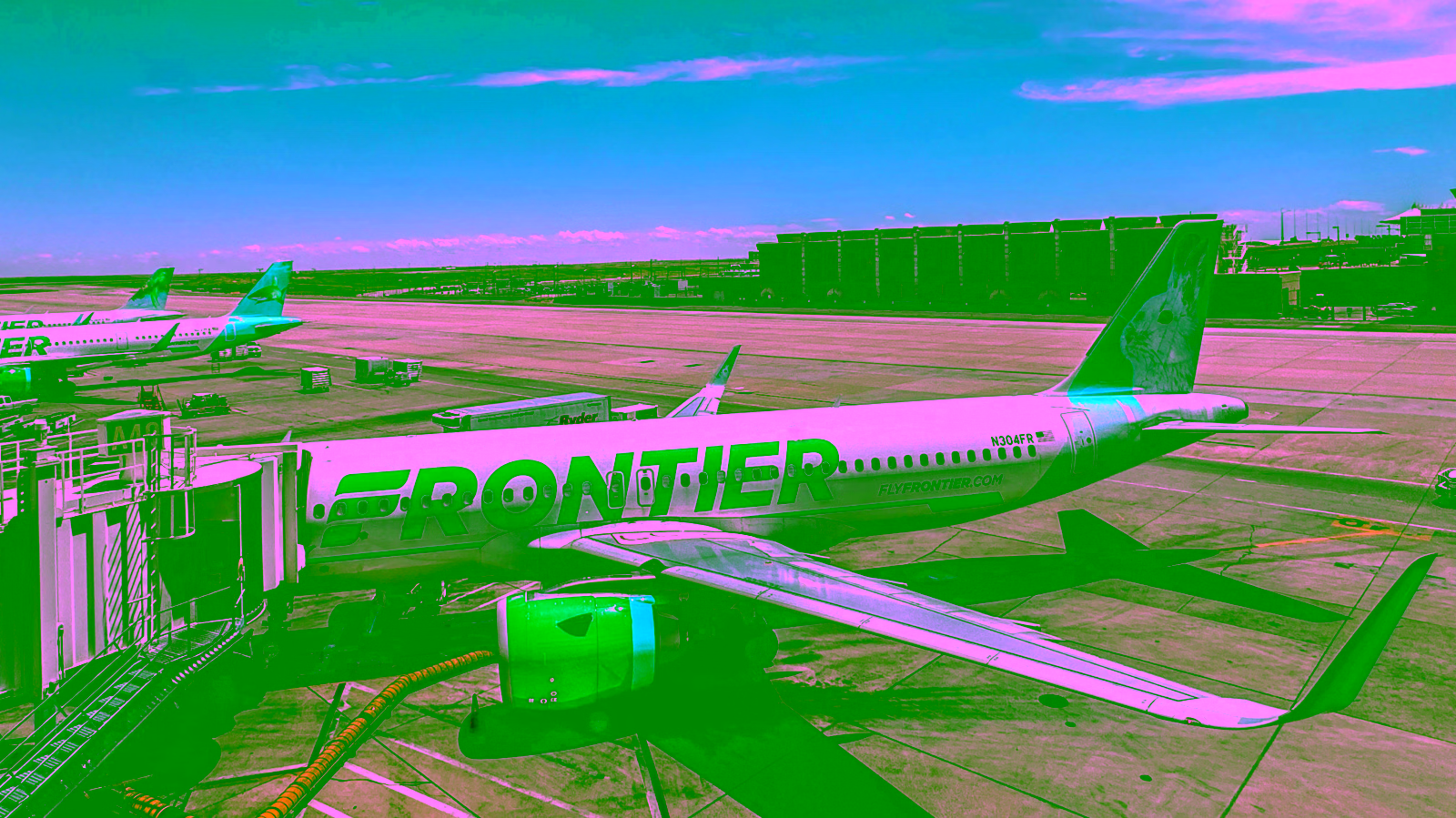 Frontier Airlines plane at airport gate