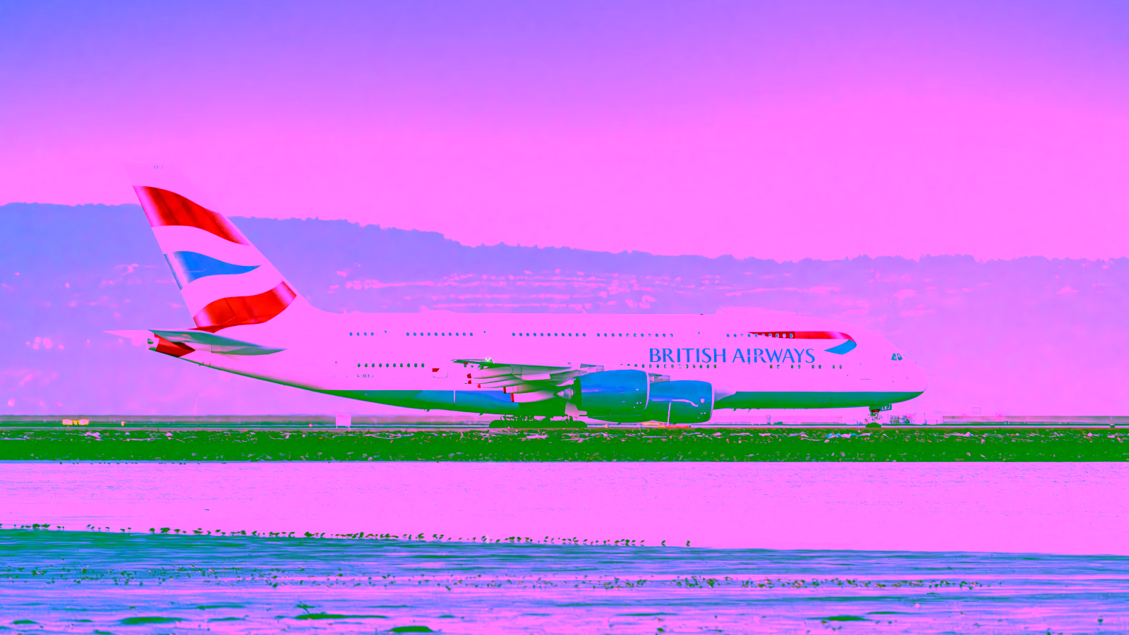 British Airways plane on runway near water
