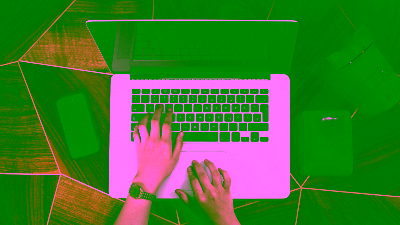 Hands typing on laptop keyboard